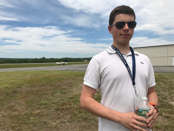 Pilot Alec J. Liberman, 17, who took his first Young Eagles flight three years ago, waits to give a flight to the next group at the Aero Fair at the Fitchburg Airport Sunday. [Photo/Paula J. Owen]