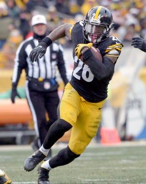 Steelers running back Le'Veon Bell runs with the ball during the Steelers' wild-card playoff game against the Miami Dolphins on Jan. 8 at Heinz Field in Pittsburgh.