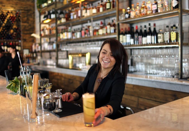 Taelor Severing, bartender at South Village Grille, places the final touches on "The Dalton." [Brooke LaValley/Dispatch]