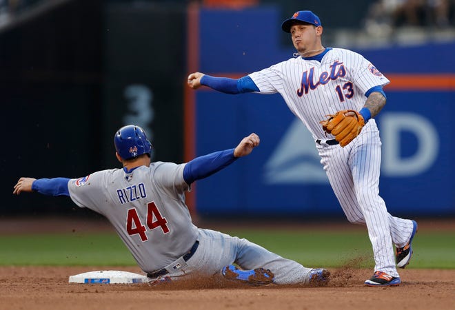 New York Mets shortstop Asdrubal Cabrera (13) throws to first after forcing out Chicago Cubs' Anthony Rizzo (44) after the Cubs Ben Zobrist hit into a third-inning double play in a baseball game, Monday, June 12, 2017, in New York. (AP Photo/Kathy Willens)