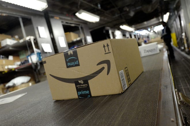 A package from Amazon Prime moves on a conveyor belt at a UPS facility in New York. [AP Photo / Mark Lennihan]