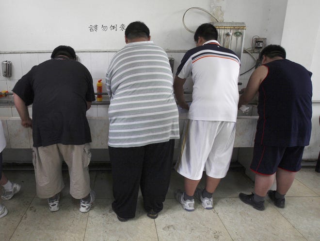 In this 2008 file photo, obese patients wash their plates after lunch at the Aimin Fat Reduction Hospital in Tianjin, China. The hospital uses a combination of diet, exercise and traditional Chinese acupuncture to treat rising obesity rates. Research released Monday found the obesity epidemic is getting worse in most parts of the world, according to data between 1980 and 2015. [Ng Han Guan, Associated Press]
