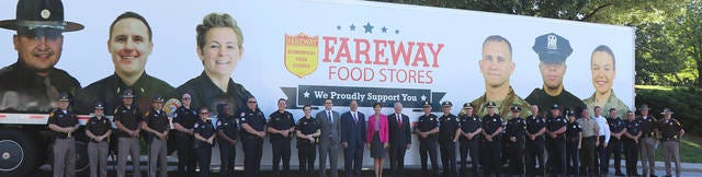 Law enforcement officers whose pictures are included on Fareway trucks as part of the Boone-based company’s campaign to thank public service employees are pictured with Gov. Kim Reynolds and Lt. Gov. Adam Gregg, during the unveiling of the campaign May 24. Photo contributed by Fareway