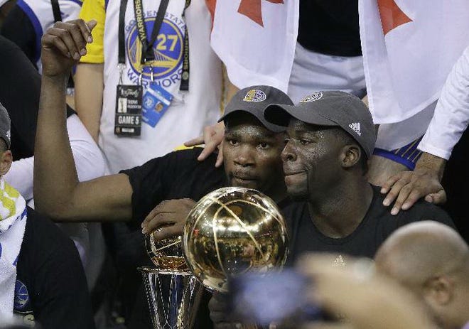 Golden State Warriors forward Kevin Durant, left, and forward Draymond Green celebrate after Game 5 of basketball's NBA Finals against the Cleveland Cavaliers in Oakland, Calif., Monday, June 12, 2017. The Warriors won 129-120 to win the NBA championship. (AP Photo/Marcio Jose Sanchez)
