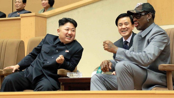 North Korean leader Kim Jong Un, left, talks with former NBA player Dennis Rodman, right, as they watch an exhibition basketball game at an indoor stadium Jan. 8, 2014, in Pyongyang. (Korean Central News Agency/Korea News Service via Associated Press, file)