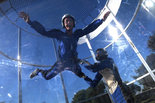 Cindy Cicala, left, and John Suiter test the skydiving simulator as they prepare for today's opening of the San Joaquin County Fair. [CALIXTRO ROMIAS/THE RECORD]