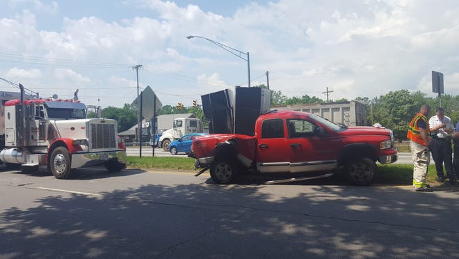 A Dodge Ram 1500 truck with three occupants was hit from behind by a semi-tractor trailer around 11 a.m. Tuesday on state Rotue 21 at Lake Avenue. Thre truck's occupants were taken to Affinity Medical Center. (IndeOnline.com / Amy L. Knapp)