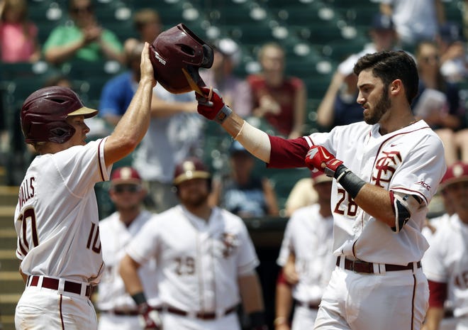 Florida State's Dylan Busby, right, a Sarasota High grad, is congratulated by teammate Taylor Walls after hitting a home run against Duke during the Atlantic Coast Conference baseball tournament in Louisville, Ky., on May 27. [WADE PAYNE / THEACC.COM via AP]