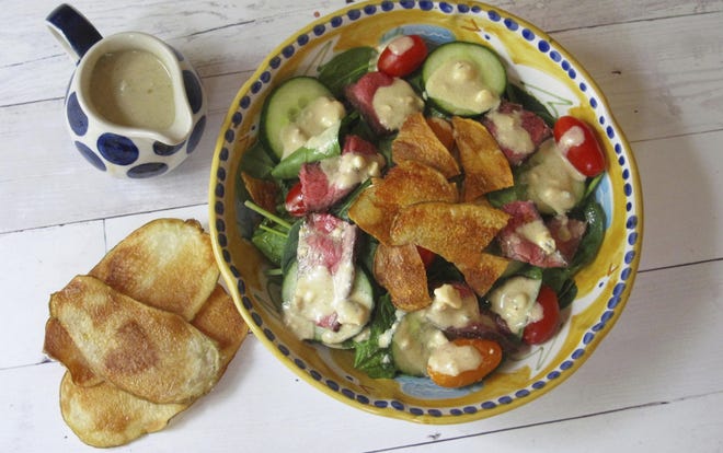 AP PHOTO/SARA MOULTIN Warm steak and potato chip salad with blue cheese dressing captures the best flavors of the steakhouse in a health-conscious dish.