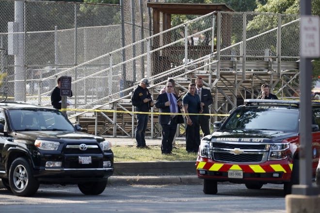 Officers investigate the scene of a shooting at a baseball field in Alexandria, Va., on Wednesday morning, where House Majority Whip Steve Scalise, R-La., was among five injured at a practice for GOP members of Congress for a charity baseball game. [Alex Brandon/The Associated Press]