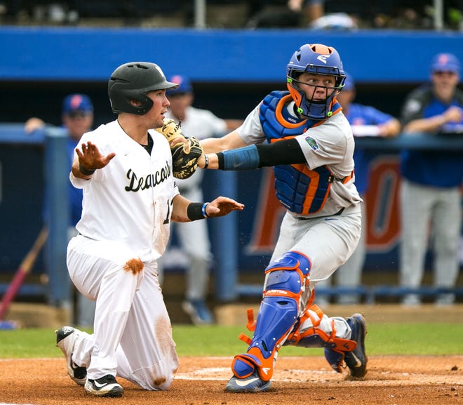 Florida catcher JJ Schwarz tags Wake Forest's Keegan Maronpot out at home in Game 2 of the NCAA Super Regional at McKethan Stadium on Monday. The Demon Deacons won 8-6 to force Game 3, which UF won 3-0 Monday night. [Cyndi Chambers / Gatehouse Media]