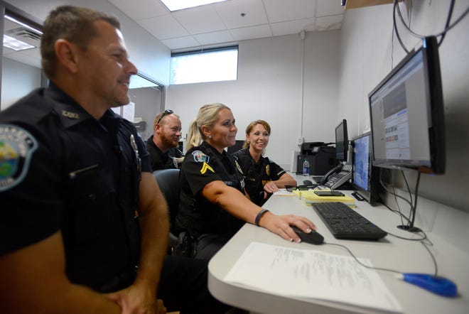 Members of the social media team look over Facebook at the Tavares Police Department on Tuesday. Some law enforcement agencies like the Tavares police and Sheriff's Office are utilizing Facebook and social media more to engage with community members. [AMBER RICCINTO / DAILY COMMERCIAL]