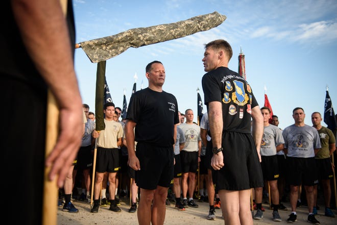 Col. Tobin Magsig, right, and Command Sgt. Maj. Robert Cobb, of the 1st Brigade Combat Team, finish casing the colors after a brigade run Wednesday on Fort Bragg. More than 1,600 soldiers with the 1st Brigade Combat Team will be deploying. [Andrew Craft/The Fayetteville Observer]