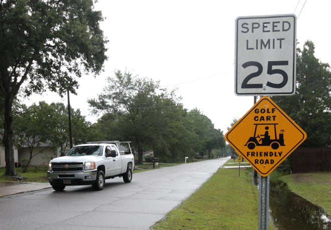 A sign for a “golf-cart friendly” neighborhood is on display Wednesday in Lynn Haven. Commissioners have approved an expansion of the ordinance, allowing for golf carts on streets with speed limits of 25 mph or less. [PATTI BLAKE/THE NEWS HERALD]