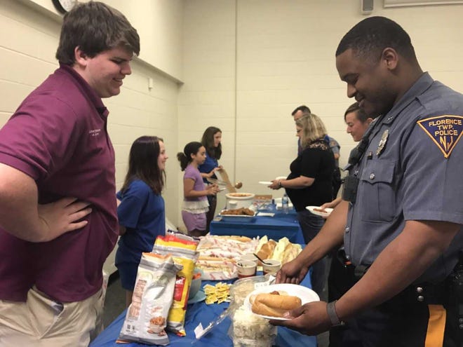 Florence Officer Anthony Johnson takes part in a buffet-style lunch hosted Thursday, June, 15, 2017, by the South Jersey Home School K-Kids, a service group associated with the Kiwanis Club, that allowed law enforcement members to answer questions about what they do.