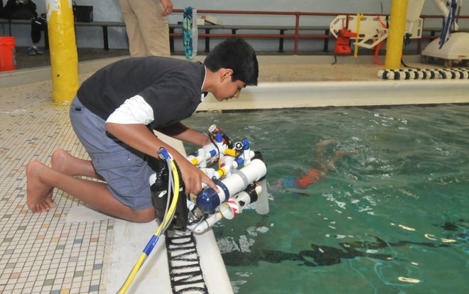 Abhi Kotgire, 14, of Mount Laurel, launches an underwater robot. He and his teammates from the Thomas E. Harrington Middle School will compete in an international robotics competition in California.