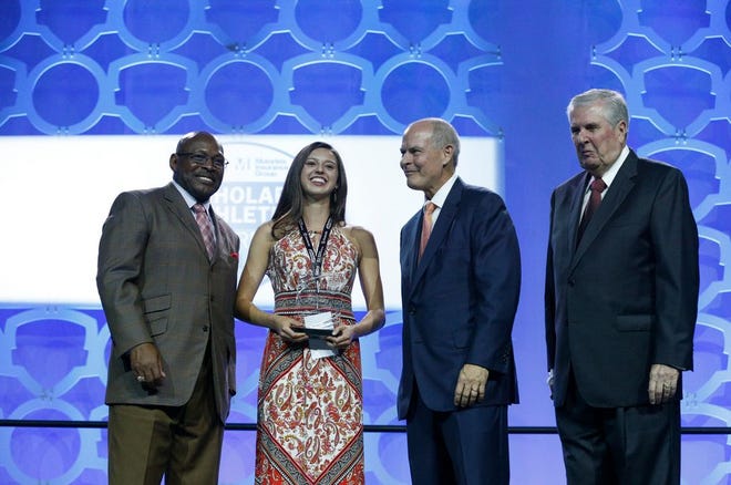 Audrey Grammel, of Columbus Academy, accepts the Top Female Scholar Athlete Award with Archie Griffin, left, David Kaufman, second from right, and John J. Bishop, right, during The Columbus Dispatch and Motorists Insurance Group Scholar Athlete Awards on Wednesday, June 7, 2017 at the Greater Columbus Convention Center in Columbus, Ohio.[Joshua A. Bickel/Dispatch]