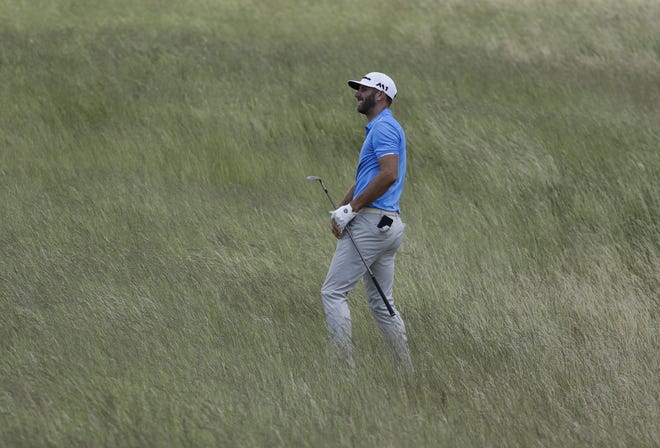 Dustin Johnson hits from some tall fescue on the 12th hole during a practice round for the U.S. Open golf tournament Wednesday, June 14, 2017, at Erin Hills in Erin, Wis. (AP Photo/David J. Phillip)