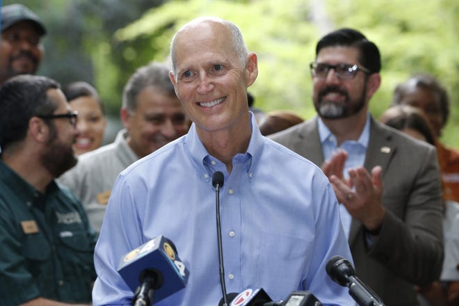 Florida Gov. Rick Scott smiles as he speaks during a news conference at Jungle Island zoological park Tuesday in Miami. [Wilfredo Lee / AP]