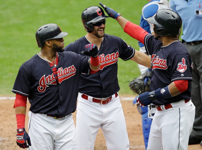 Cleveland Indians' Lonnie Chisenhall, center, is congratulated by Edwin Encarnacion, right, and Carlos Santana after Chisenhall hit a three-run home run in the fifth inning of a baseball game, Thursday, June 15, 2017, in Cleveland. Encarnacion and Santana scored on the play. (AP Photo/Tony Dejak)
