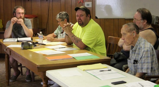 Waldron Village Council, led by President Leo Burress (center), met Tuesday night to approve the year's tax rates and discuss possibly increasing police presence in the village, among other things. [ANDREW KING PHOTO]