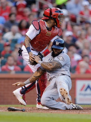 Milwaukee Brewers' Eric Thames is tagged out at home by St. Louis Cardinals catcher Yadier Molina as he tried to score from second on a single by Travis Shaw during the fifth inning of a baseball game, Thursday, June 15, 2017, in St. Louis. (AP Photo/Tom Gannam)
