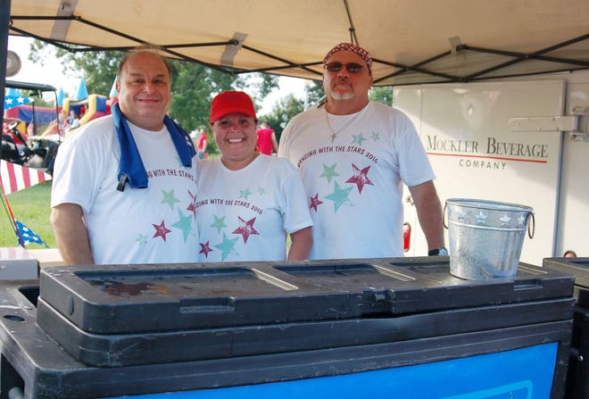 In beer booth are, from left, Bobby Blanchard, and Michelle and Jeff Sharon.