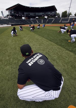 Ems players stretch before their first workout of the season at PK Park in Eugene. The defending Northwest League Champions open their season on Thursday. (Andy Nelson/The Register-Guard)