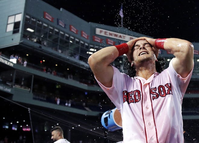 Red Sox's Andrew Benintendi celebrates after his game-winning RBI single in the 12th inning of the team's game against the Philadelphia Phillies Tuesday. The Red Sox won 4-3. [Charles Krupa/The Associated Press]