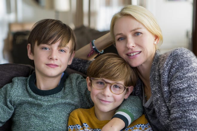 Henry (Jaeden Lieberher), Peter (Jacob Tremblay), and Susan (Naomi Watts) find a moment of happiness. [Courtesy of Focus Features]