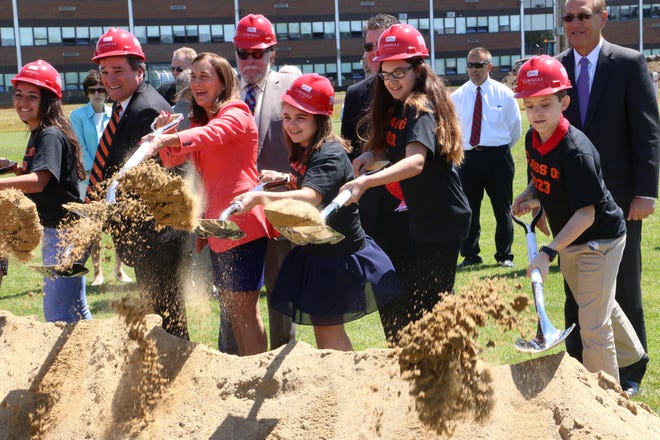 The Classes of 2017-2023 shovel dirt at the groundbreaking for the new high school in Stoughton on Thursday, June 16, 2017.
