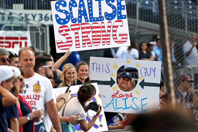 Supporters of House Majority Whip Steve Scalise, R-La., hold signs before the Congressional baseball game, Thursday, June 15, 2017, in Washington. The annual GOP-Democrats baseball game raises money for charity. (AP Photo/Alex Brandon)