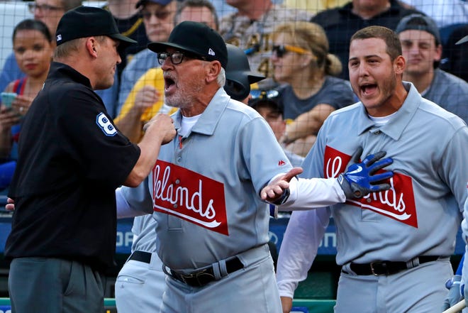 Chicago Cubs manager Joe Maddon, center, argues with umpire Jeff Kellogg, left, over a home run that was called a foul ball by Anthony Rizzo, right, who is restrained from getting into the discussion by Kyle Schwarber in the first inning of a baseball game against the Pittsburgh Pirates in Pittsburgh, Friday, June 16, 2017. Maddon was eventually eject from the game by Kellogg. Rizzo drew a walk of Pirates starting pitcher Trevor Williams. (AP Photo/Gene J. Puskar)