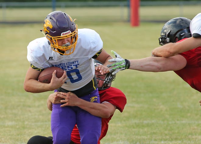 The East’s Alec Seel (Onsted), front, rushes against the West’s Damon Hassenzahl (Tecumseh) on Friday night.