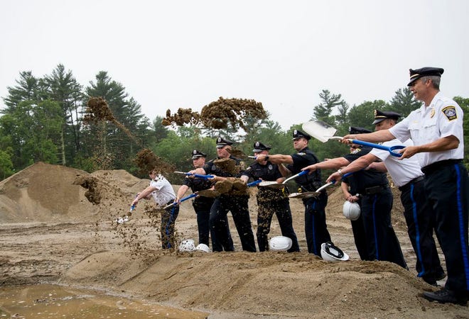 Members of the Middleboro Police Department help break ground on the department's new police station Saturday, June 17, 2017.
