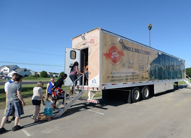 Visitors file into the Mobile Bible Exhibit parked at the First Alliance Church in Millcreek Township. [JACK HANRAHAN/ERIE TIMES-NEWS]