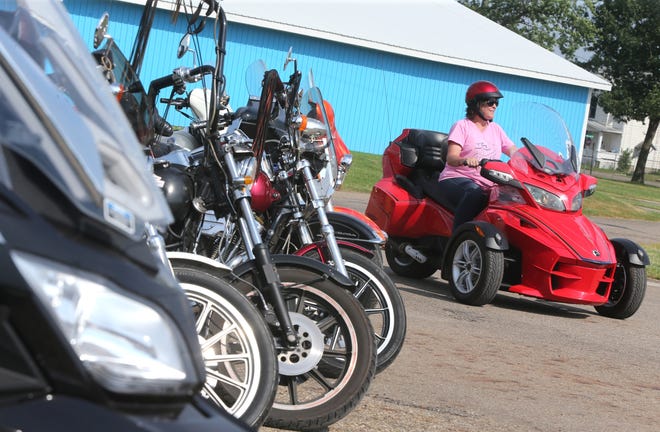 Linda Pedigo pulls into the Stark County Fairgrounds on her Can-Am touring bike during the F.A.T.H.E.R.S. Motorcycle Poker Run and Community Event in Canton on Saturday. Her husband Donald also rode in the event. (CantonRep.com / Scott Heckel)