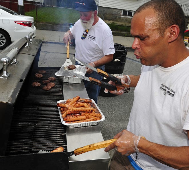 Jerry Pintoand Kenny Resandes keep the food grilling. [DAVID W. OLIVERIA/STANDARD-TIMES SPECIAL/SCMG]