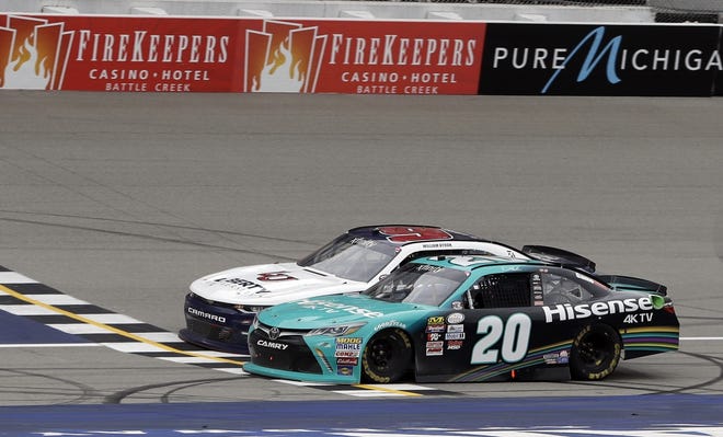 Denny Hamlin, inside, edges out William Byron by 0.012 seconds at the finish line Saturday to win the NASCAR Xfinity Series race in Brooklyn, Mich. [THE ASSOCIATED PRESS]