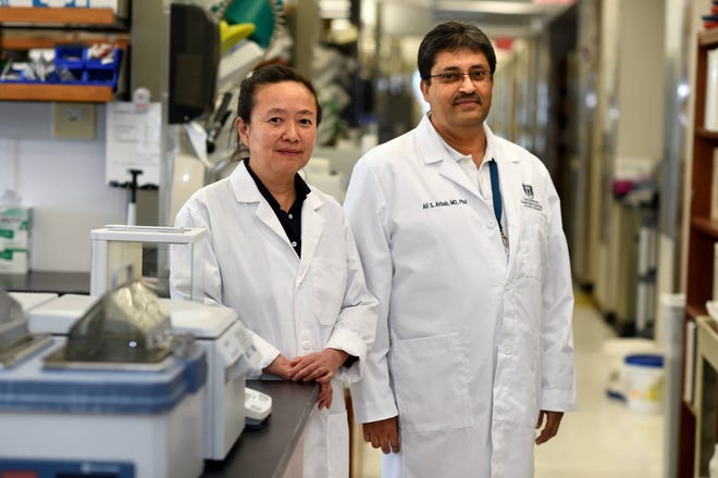 Cancer researchers Dr. Lan Ko, left, and Dr. Ali Arbab photographed in their Georgia Cancer Center research building lab Friday afternoon June 9, 2017. MICHAEL HOLAHAN/AUGUSTA CHRONICLE