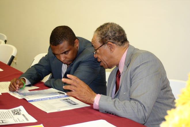 Malcolm Beech. right, shares a thought with North Carolina Sen. Don Davis at the African American Museum and Culture Center Fundraiser Event that was held at the Golden Progress Community Center on S. Queen Street in Kinston on Saturday night. [Andy Thomas, Jr./ The Free Press]