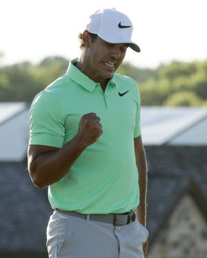 Brooks Koepka after shooting par on the 18th hole during the U.S. Open on Sunday. Koepa won the championship after shooting 16 under throughout the four rounds, tying Rory McIlroy's record. [AP Photo/Charlie Riedel]