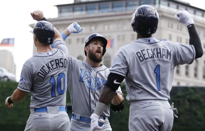Tampa Bay Rays' Steven Souza Jr., center, celebrates with Corey Dickerson (10) and Tim Beckham (1) after hitting a grand slam against the Detroit Tigers during the third inning Sunday in Detroit. The Rays won, 9-1. [THE ASSOCIATED PRESS / DUANE BURLESON]