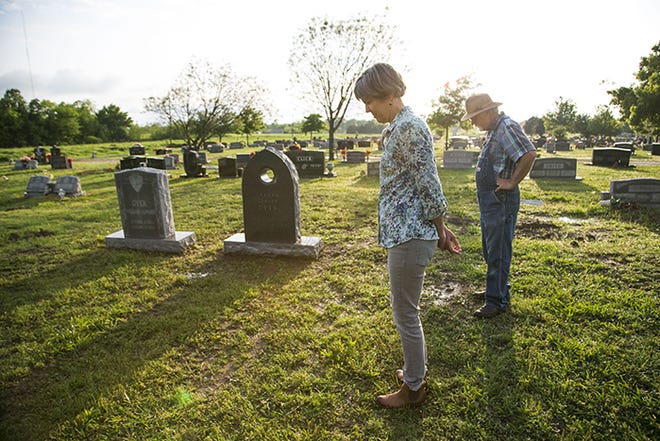 Kathy and Robert Dyer stand by the headstone marking the gravesite of their son, Graham, in Evergreen Cemetery in Paris, Texas on Monday, April 10, 2017. Kathy designed the headstone herself, with a circular opening in the top. “To me it represents passing through from this side of death to the other side,” she said. Dyer's 18-year-old son, Graham, was killed while in police custody in 2013. The Dyers spent two years trying to get the police records about his death, due to a Texas law that says a police agency isn't required to turn over records for incidents that don't result in a conviction.