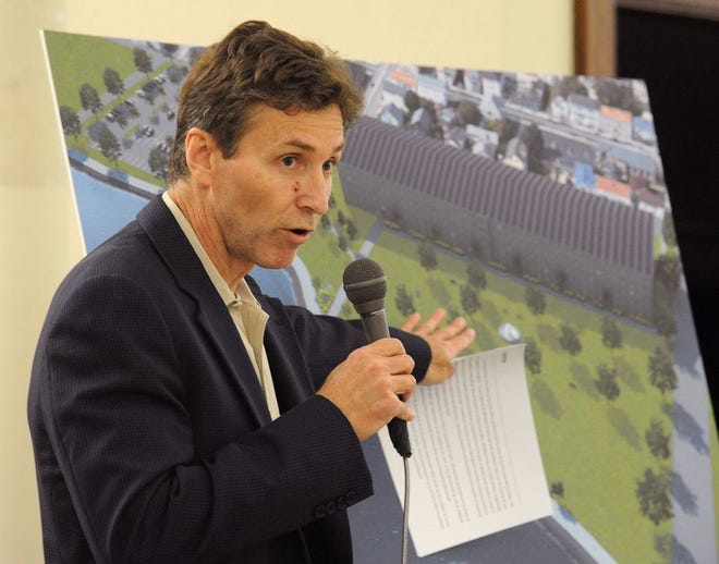 Addressing the South End Neighborhood Association in early May, developer Richard DeRosas reveals his proposed plan to turn the King Philip Mill property into market-rate apartments and a waterfront park.
