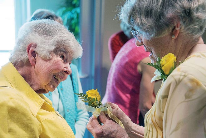Virginia Coleman, now 94, was a chemist at the Y-12 lab during the Manhattan Project in Oak Ridge. Susan Fredrick tells Coleman's life story below and in future 'Historically Speaking' columns. Here, Coleman receives a yellow rose from Betsy Smith to commemorate 50 years membership in the League of Women Voters of Oak Ridge in 2016.