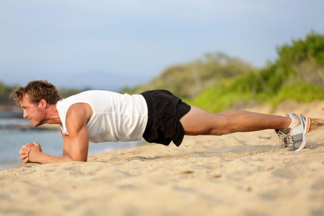 Planking works the full body. Make sure you're not rounding your back. [Dreamstime / TNS]
