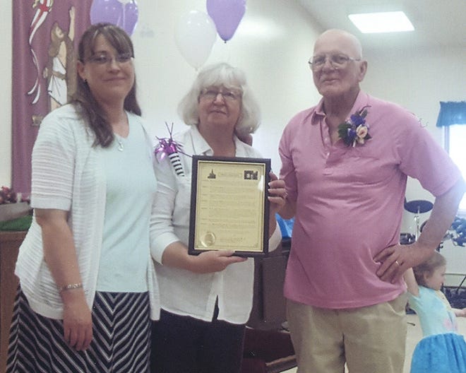 Rev. Janet Gleason was presented with a proclamation from Herkimer County Legislature Chairman Bernard Peplinski, Sr. which states Peplinski deems “it fitting and appropriate to proclaim Sunday, June 18, 2017, as ‘Rev. Janet Gleason Day’ and to urge the residents of the county to join in the recognition of her many years of ministry and to her service to the First United Methodist Church of Herkimer and to the community.” From left are Kathy Fox, director of the Herkimer County Office for the Aging, Rev. Janet Gleason and Mike Gleason. [SUBMITTED PHOTO]