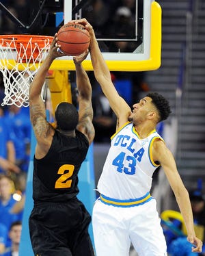 In this Jan. 9, 2016 file photo, UCLA's Jonah Bolden blocks a shot by Arizona State's Willie Atwood in the second half of an NCAA college basketball game in Los Angeles. Bolden is an Australian-born forward who played one season at UCLA, then left and has since been playing in pro leagues in Australia and Serbia. Bolden is hoping to be picked in Thursday's NBA Draft. [MICHAEL OWEN BAKER/ASSOCIATED PRESS]