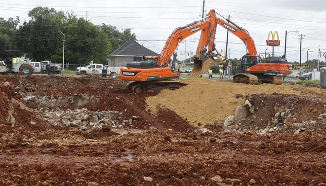 Demolition of the old Central YMCA is complete and a pair of track hoes worked Tuesday to clear the site at the corner of Lurleen Wallace Boulevard North and Paul W. Bryant Drive of any remaining debris. [Staff Photo/Gary Cosby Jr.]